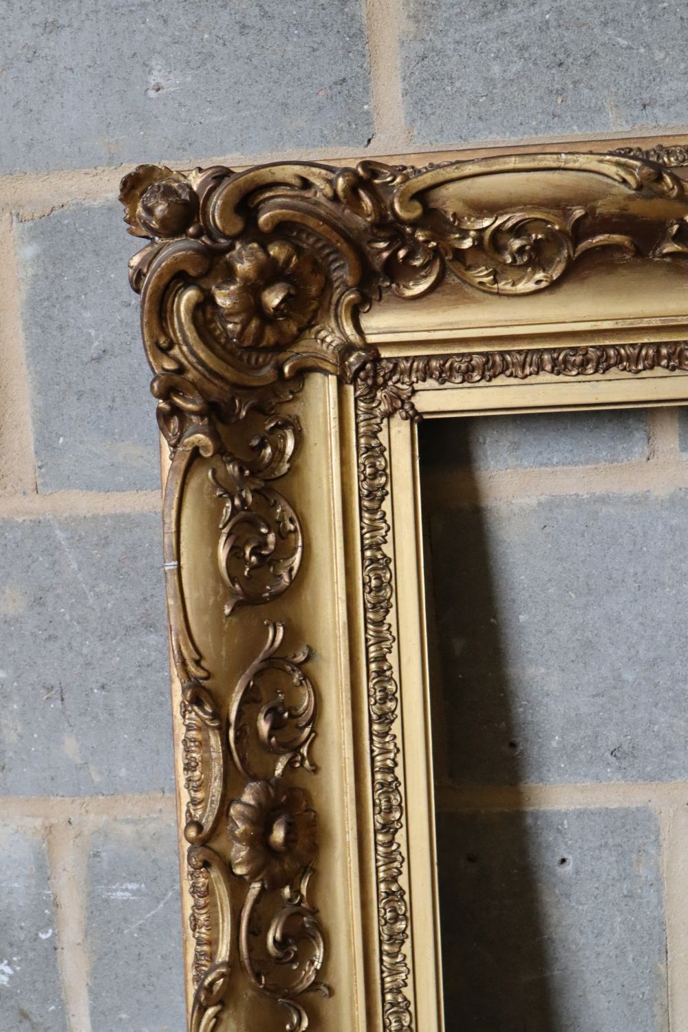 A Victorian carved giltwood and gesso picture frame, width 101cm height 87cm, aperture width 68 x 54cm